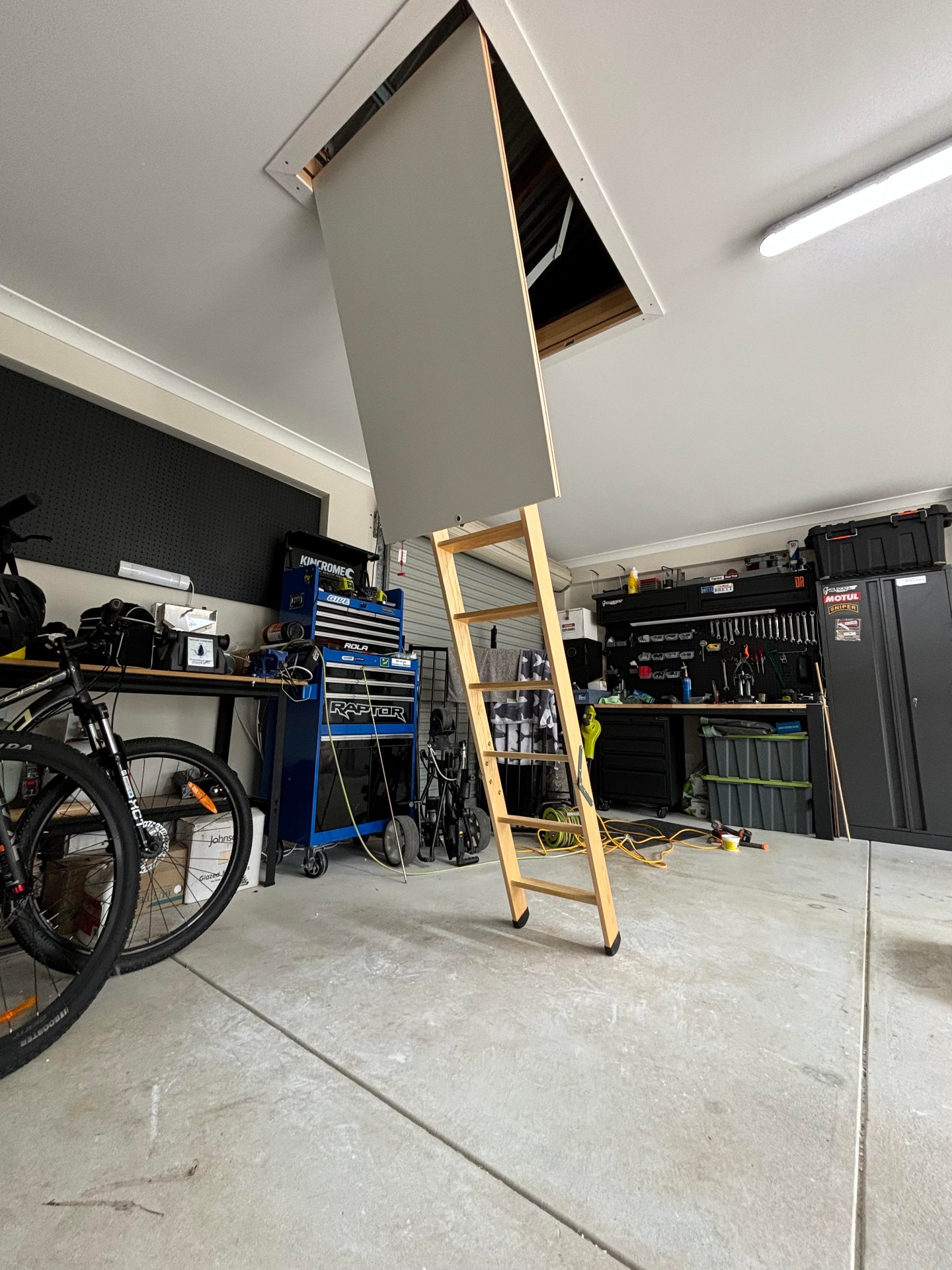 Attic ladder installed in a garage ceiling